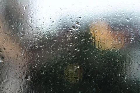 Rain drops running down the window surface. Stock Photos