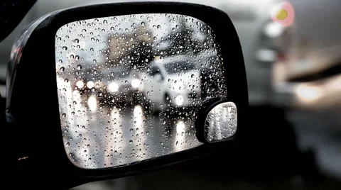 Rain drops on side mirror, Blurred of traffic in side mirror view on a rainy day Stock Footage 64230791