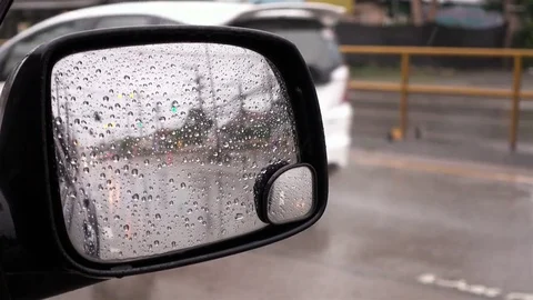 Rain drops on side mirror, Blurred of traffic in side mirror view on a rainy day Stock Footage 72899034