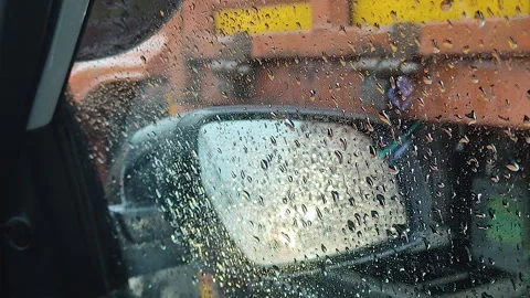Rain drops on side mirror close up with truck stuck in traffic jam Stock Footage 344851114