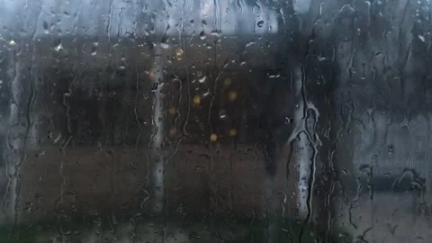 Rain drops sliding on window glass during rainy weather, Stock Footage 334057469