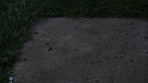 Rain drops in slow motion hitting the ground close up Stock Footage 153123294