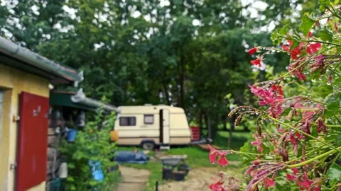Rain drops on the spider web and caravan view Stock Footage 141711407