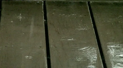 Rain drops splashing on deck  Stock Footage 2654975