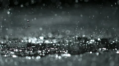 Rain drops splashing in puddle Stock Footage