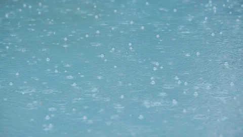 Rain drops splashing in the swimming pool Stock Footage 128226322