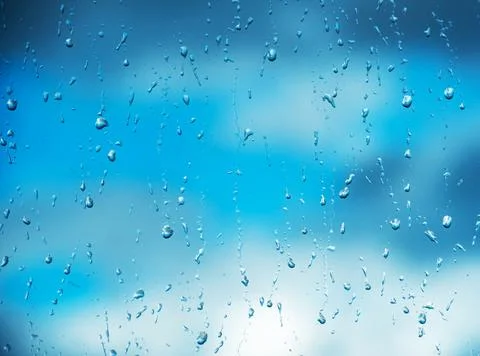 Rain drops on surface of the window glass with cloud background. Natural pattern Stock Photos