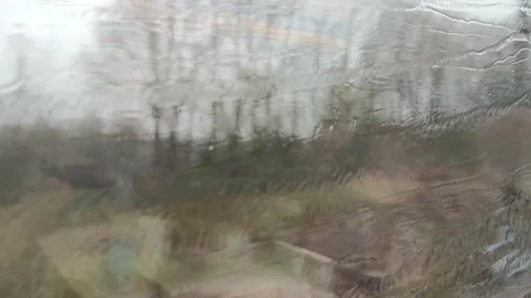 Rain drops on train window glass. Video stock 164253988