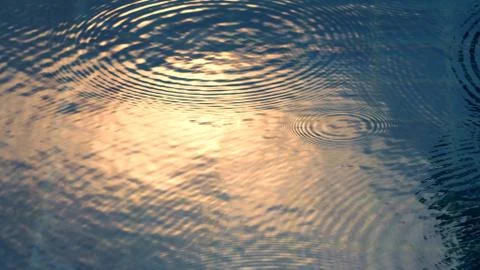 Rain drops on the water pool Stock Photos
