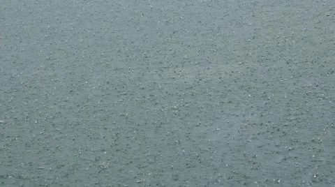 Rain Drops on Water Surface Stockbeeldmateriaal 60048037
