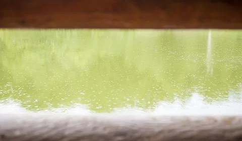 Rain drops on the water, through two wooden beams. An autumnal concept, and an Photos