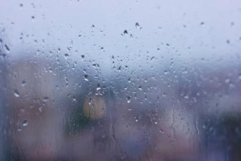 Rain drops on a wet window. Gray dampness Stock Photos
