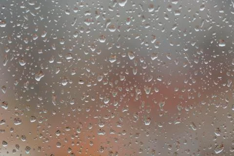 Rain drops on window, against blurry background of a town 스톡 사진