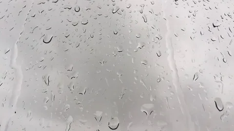 Rain drops on window against mood sky Stock Footage 83970837