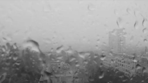 Rain drops on the window and city outside black and white Stock Footage 82368512