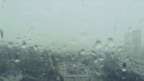 Rain drops on window and the city outside Stock Footage 82368642