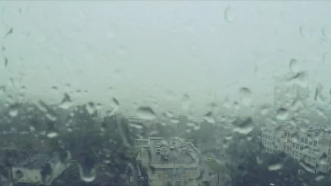 Rain drops on the window and the city outside Stock Footage 82370066