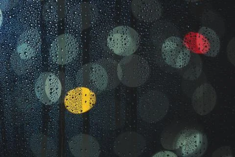 Rain drops on the window, and defocused city lights Stock Photos