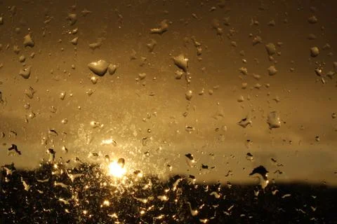 Rain drops on window and sunset Stock Photos