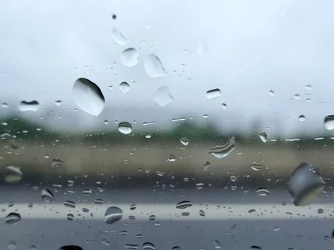Rain Drops on Window with Blurred Landscape Background Fotos de archivo