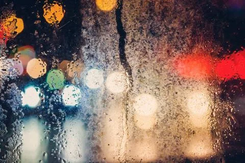 Rain drops on window with blurry background Stock Photos