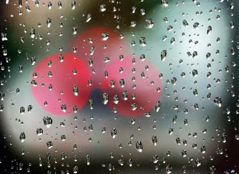 Rain drops on window with bokeh lights Stock Photos