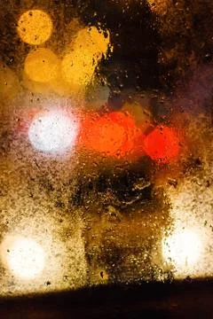 Rain drops on window with bokeh Stock Photos