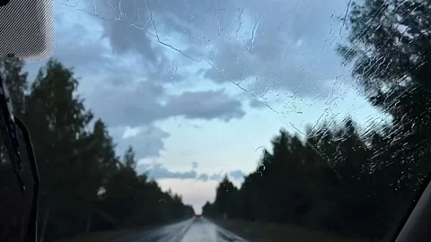 Rain drops on window car windshield. View from the inside of a driving car. Stock Footage 208174707