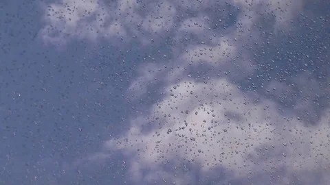 Rain drops on the window - the clouds are floating in the sky Stock Footage 76356983