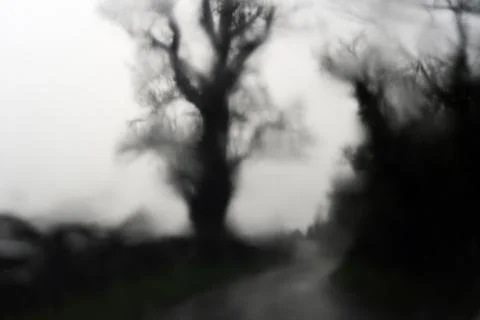 Rain drops on a window, creating a blurred spooky abstract view Stock Photos
