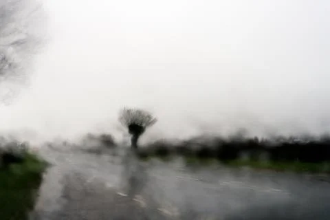 Rain drops on a window, creating a blurred spooky abstract view Stock Photos