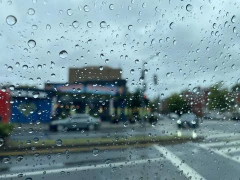 Rain drops on window during storm. Street view. Stock Photos