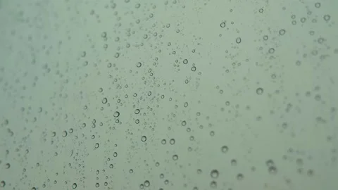 Rain drops on window glass. Large rain drops strike a window pane. Stock Footage 134369674