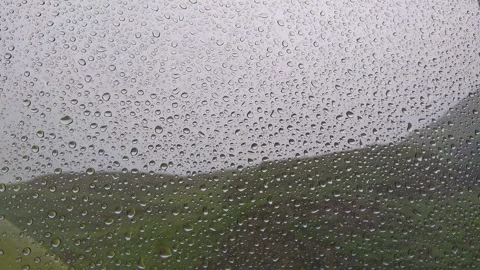 Rain drops on a window glass. Mountain landscape in the background Stock Footage 91158890