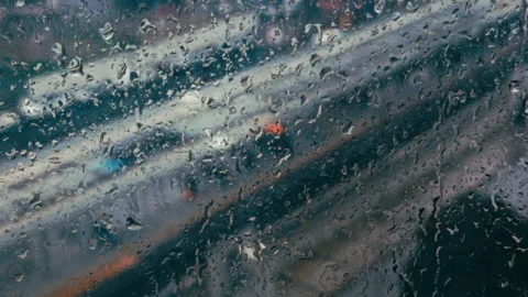 Rain Drops on Window Glass nad Blurry City Life Stock Footage 329133173