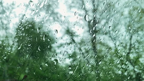 Rain drops on window glasses surface with cloudy background. Driving in rain Stock Footage 195241878