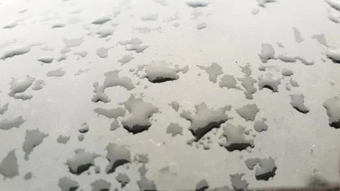 Rain drops on window glasses surface with cloudy background Stock Photos