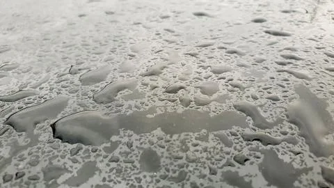 Rain drops on window glasses surface with cloudy background Stock Photos