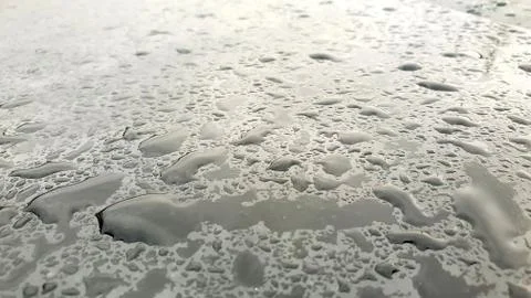 Rain drops on window glasses surface with cloudy background Stock Photos