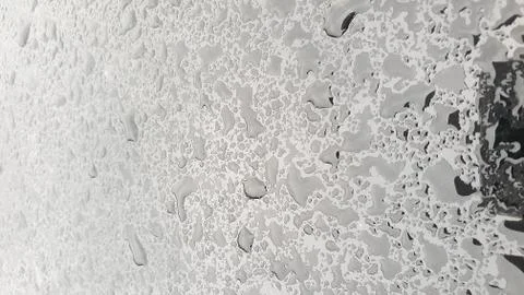 Rain drops on window glasses surface with cloudy background Stock Photos