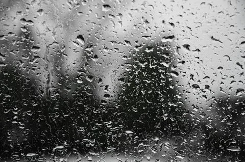 Rain drops on window glasses surface with cloudy background . Natural Pattern Stock Photos