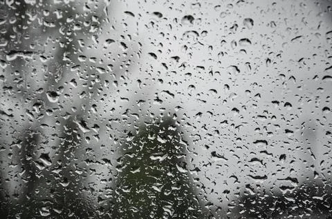 Rain drops on window glasses surface with cloudy background . Natural Pattern Stock Photos