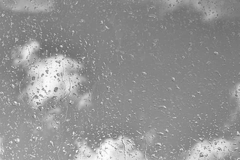 Rain drops on window glasses surface with gray sky background. Natural back.. Stock Photos