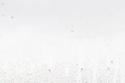 Rain drops on window glasses surface with gray sky background . Natural bac.. Stock Photos