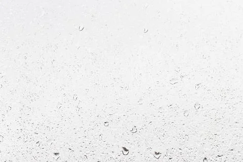 Rain drops on window glasses surface with gray sky background . Natural bac.. Stock Photos