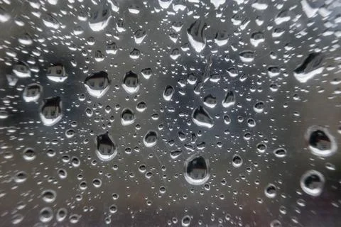 Rain drops on window glasses surface with cloudy background . Natural Pattern Фото