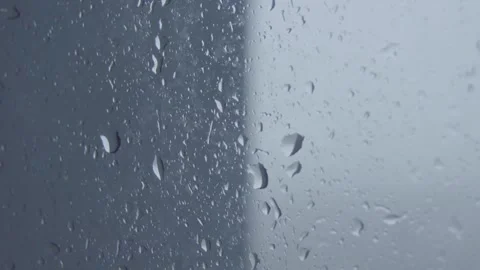 Rain drops on window with gray and white background Stock Footage 249048228