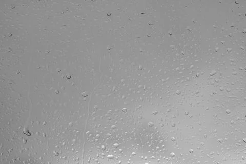 Rain drops on a window indicating gray and rainy day Stock Photos
