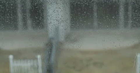 Rain drops window. Large rain drops strike a window pane during a summer shower Stock Footage 256045573