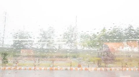 Rain drops on window mirror with green trees, Rainy day window in office Stock Photos